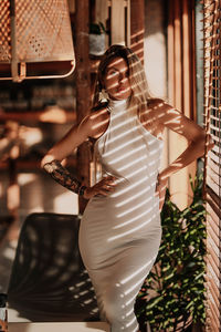 Portrait of pregnant young woman standing at cafe 