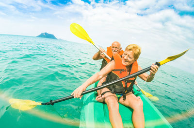 Senior couple kayaking on sea