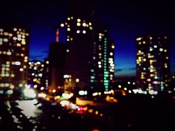 Defocused image of illuminated city at night