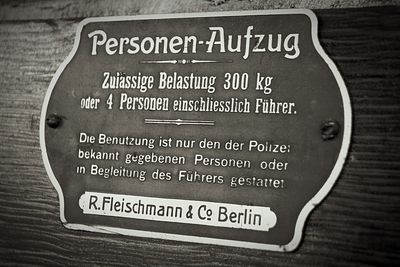 Close-up of information sign on table