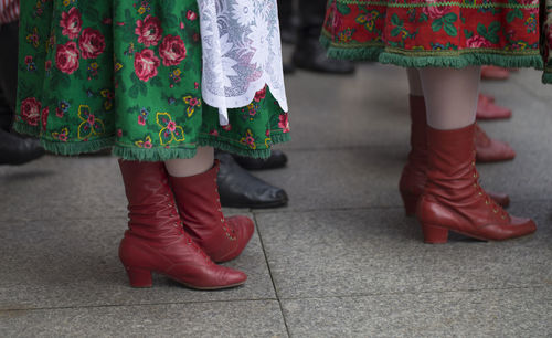 Low section of women wearing traditional clothing standing on floor