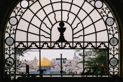 Silhouette of building seen through glass window