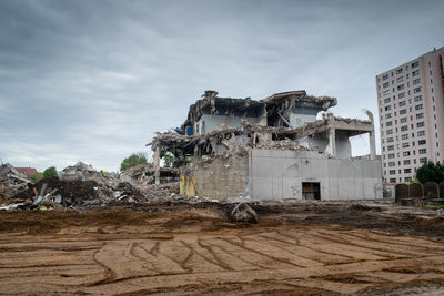 Abandoned building against sky in city