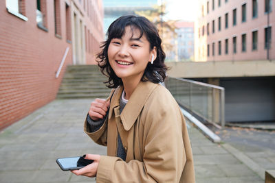 Young woman standing in city