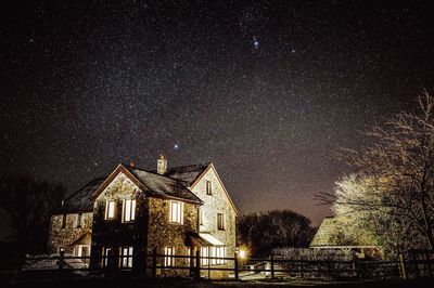 Illuminated building against sky at night