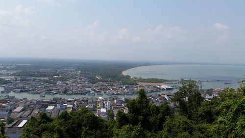 High angle view of townscape by sea against sky