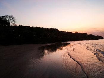 Scenic view of beach against sky during sunset