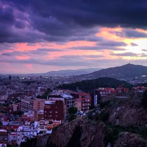 Cityscape against cloudy sky