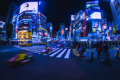 Illuminated city street and buildings at night