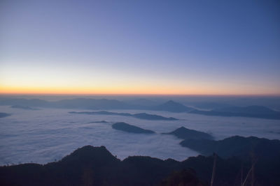 Scenic view of silhouette mountains against sky at sunset