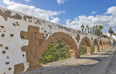 Arch bridge against sky