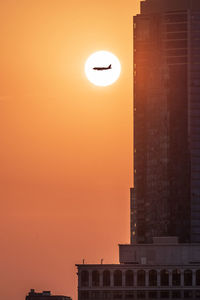 Low angle view of building against sky during sunset