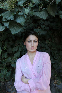 Portrait of a beautiful young woman standing outdoors