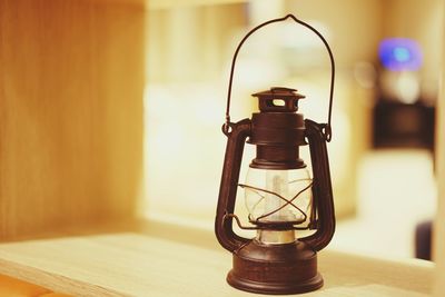 Close-up of lantern on table at home