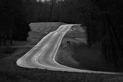 Road amidst trees in countryside