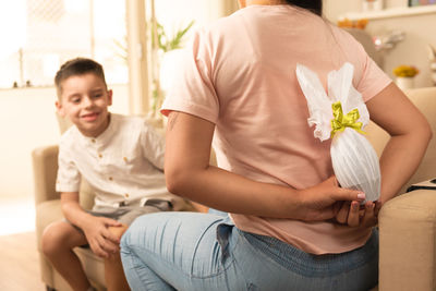 Portrait of boy blowing flowers