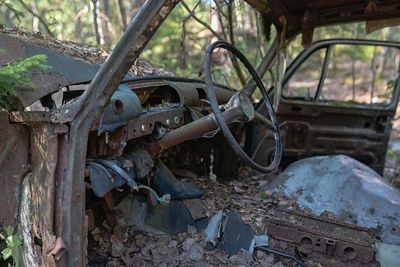 Abandoned car parked on land