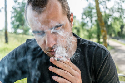 Close-up of man smoking cigarette