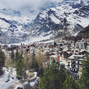 Aerial view of townscape and mountains during winter