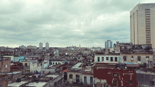 Cityscape against cloudy sky