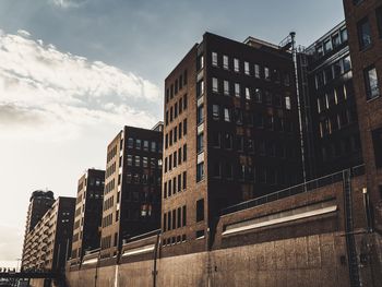 Low angle view of buildings against sky in city