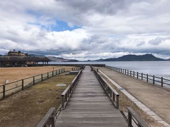 Pier over sea against sky