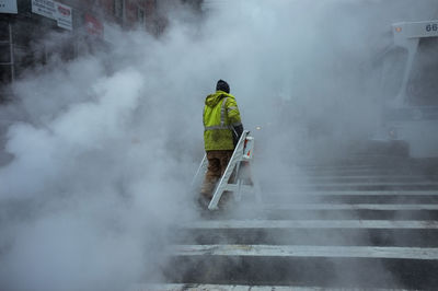 Rear view of man working