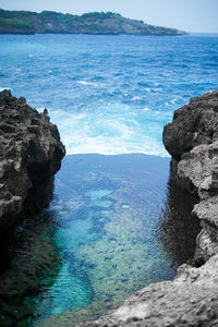 Rock formation on beach against sky