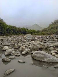 Rocks on shore against sky