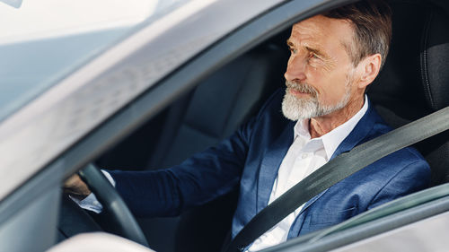 Midsection of man sitting in car