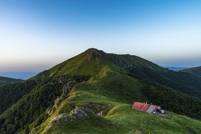 Scenic view of mountains against clear blue sky