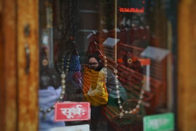 Reflection of woman seen on glass window