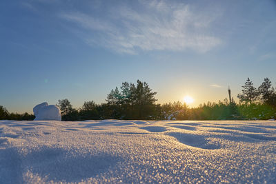 Snow covered field against sky