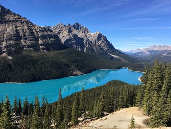 Scenic view of mountains against blue sky