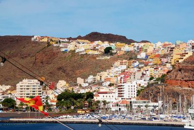 Town by sea against sky