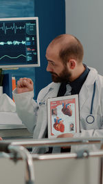 Side view of doctor examining patient in office