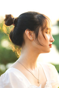 Close-up of young woman looking away