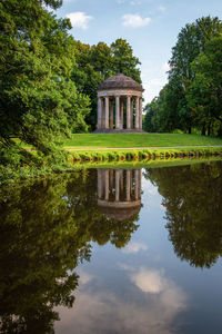 Built structure by lake against sky