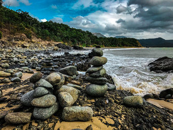 Rocks on beach against sky