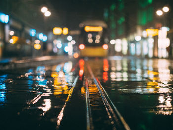 Illuminated railroad tracks at night