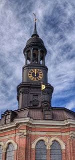 Low angle view of clock tower against sky