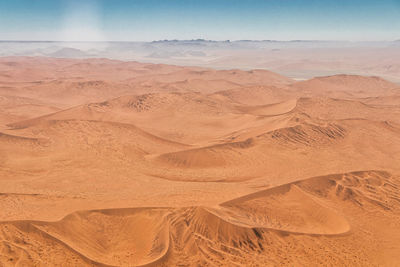 Sand dune in desert against sky