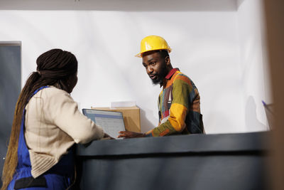 Rear view of man working at construction site