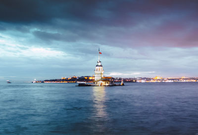 View of city by sea against sky