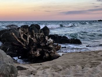 Scenic view of beach against sky during sunset