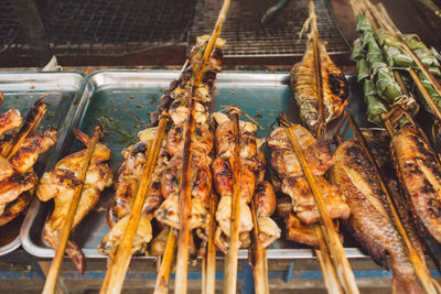 Grilled fishes and chicken meat at market for sale