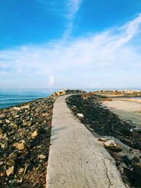 Scenic view of beach against blue sky