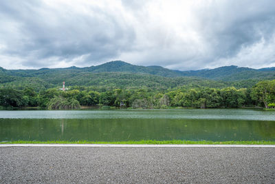 Scenic view of lake by mountains against sky