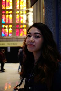 Portrait of young woman standing inside sagrada familia