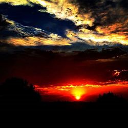 Silhouette of landscape against cloudy sky